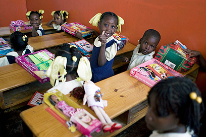 ילדים בהאיטי נרגשים לפתוח את מתנות החג שחילק ארגון צדקה (צילום: AP) (צילום: AP)