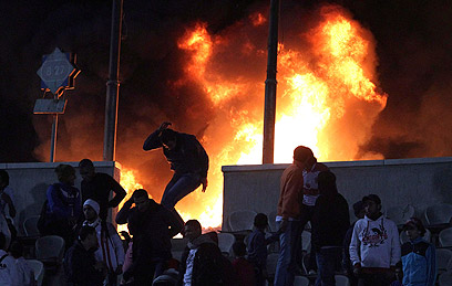 אש אצטדיון בפורט סעיד. האוהדים נמלטים (צילום: רויטרס) (צילום: רויטרס)