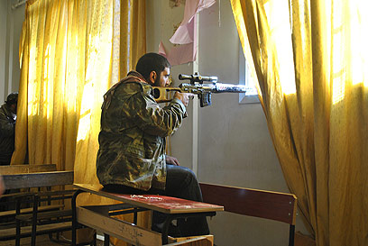 מורד סורי דרוך בעיר חומס (צילום: AP) (צילום: AP)