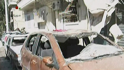 "ליד מתקן ביטחוני". זירת הפיצוץ בחלב (צילום: AFP PHOTO / SYRIAN TV) (צילום: AFP PHOTO / SYRIAN TV)