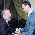 Mottaki (L) and Assad