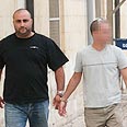 אחד החשודים בדרכו לבית המשפט