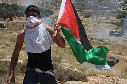 Palestinian protester on Naksa Day (Photo: EPA)