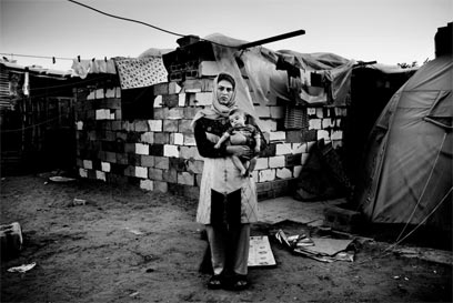 סברינה, 30, ובנה אחמד, בן חודשיים, שכונת סלטין. ביתה של סברינה נהרס במתקפה ישראלית בינואר 2009. היא קיבלה מכתב מהרשויות שמונע ממנה לבנות מחדש את ביתה. שכניה קיבלו מכתב זהה. נראה כי השכנים של האזור ההרוס הזה, המאוכלס בפליטים, ביקשו מחמאס לפנות אותם. 30 משפחות מושפעות מכך (צילום: פרדריק סוטרו) (צילום: פרדריק סוטרו)