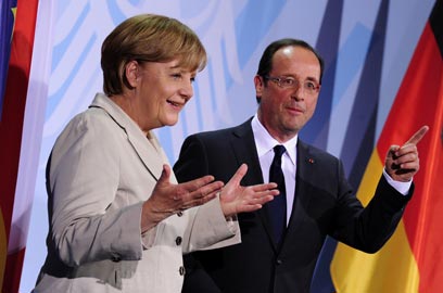קנצלרית גרמניה עם נשיא צרפת הטרי (צילום: AFP) (צילום: AFP)