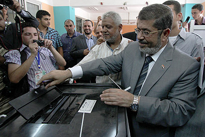 מורסי מצביע. "רוצים נשיא עם הנחישות של נאצר והכישורים הפוליטיים של סאדאת" (צילום: AFP) (צילום: AFP)