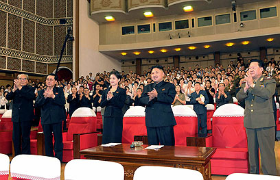 קים ג'ונג און עם אשה מסתורית לצדו בטקס ששודר (צילום: AP) (צילום: AP)