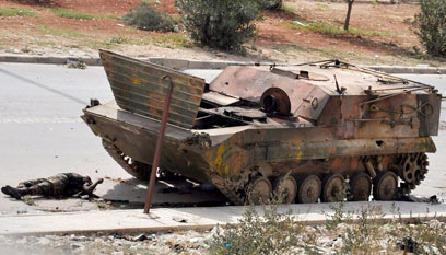 טנק וגופה חרוכה באזור שכונת סלאח א-דין (צילום: AFP) (צילום: AFP)