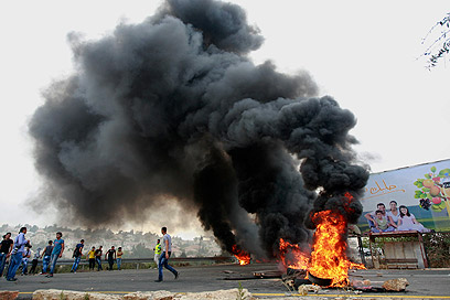 Protesters burned tires on streets (Photo: AP)