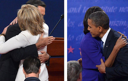 שני המועמדים מחבקים את רעיותיהם, הלילה (צילום: AFP) (צילום: AFP)