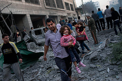 בורחים מבתיהם לאחר הפצצת האצטדיון בעזה היום (צילום: AP) (צילום: AP)