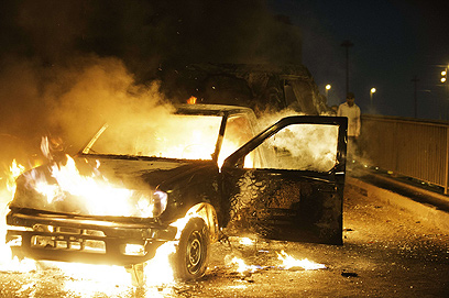 מכונית עולה באש בהתפרעויות בקהיר. גם הכסף הולך ואוזל (צילום: AFP) (צילום: AFP)