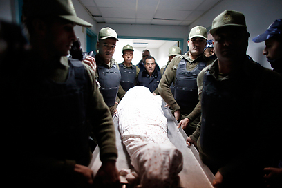 אנשי כוחות הביטחון הפלסטינים וגופתו של האסיר חמדיה (צילום: רויטרס) (צילום: רויטרס)