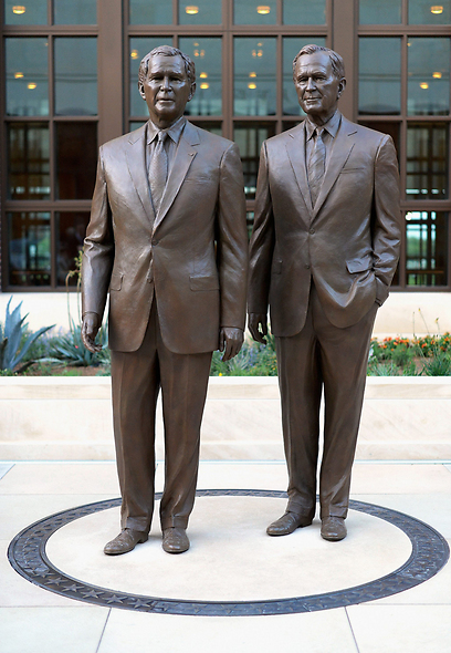 פסליהם של בוש הבן והאב בחצר המרכז (צילום: AFP) (צילום: AFP)