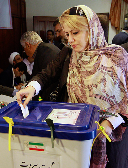 אישה איראנית משלשלת את הפתק שלה לקלפי (צילום: AP) (צילום: AP)