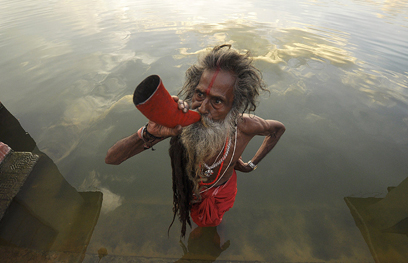 תושב העיר אגרטלה שבהודו תוקע בקרן בעיצומו של פסטיבל קארצ'י פוג'ה המסורתי (צילום: AFP) (צילום: AFP)