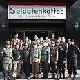 Locals dressed in Nazi uniform outside café 