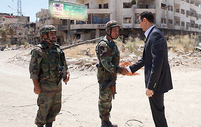 President Assad meets soldiers in Daria
