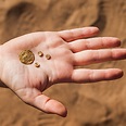 Gold coin and three items inlaid with gold that adorned jewelry 