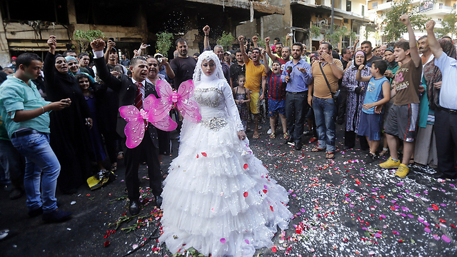 Couple at scene of attack/wedding (Photo: AFP)