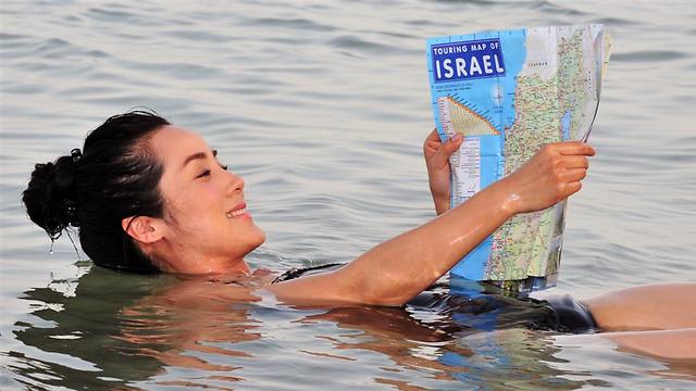 Chinese tourist relaxing in the Dead Sea (Photo: Shutterstock) (Photo: Shutterstock)