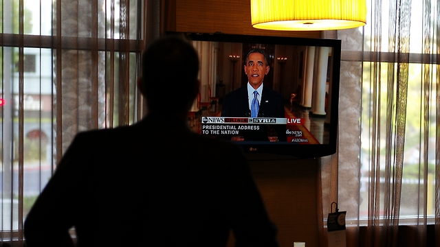 תושב אוקלנד צופה בנאום בביתו (צילום: EPA) (צילום: EPA)