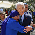 Peres receives hug from visitor 