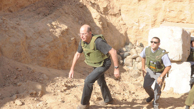Israel Defense Minister Moshe Ya'alon surveys a tunnel near Gaza (Photo: Alon Bason)