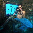 Model breathes from scuba tank during underwater photo shoot in Red Sea 