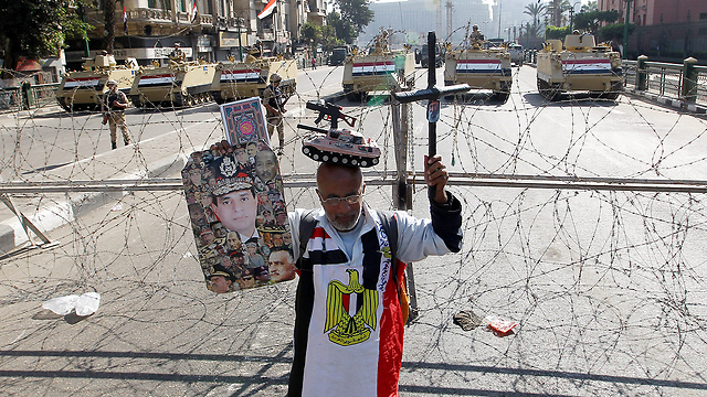 Man protests alone along army baracade (Photo: EPA)