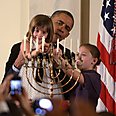 Obama lighting menorah with kids