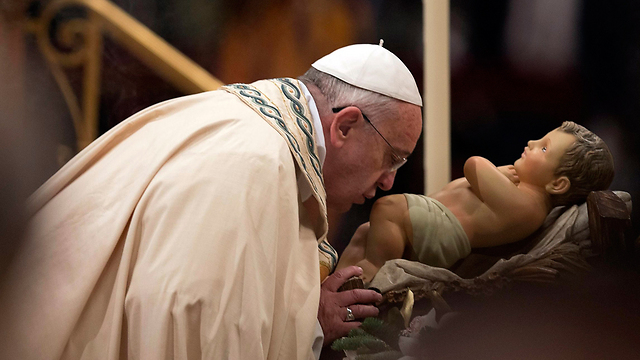 האפיפיור פרנציסקוס נושק לפסל ישו התינוק (צילום: AP) (צילום: AP)