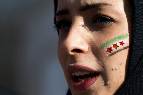 Syrian woman protests against Assad regime in Geneva (Photo: AFP)