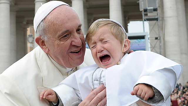 אחר כך הוא הפסיק לבכות. הפעוט דניאל בידי האפיפיור פרנסיסקוס (AFP PHOTO / OSSERVATORE ROMANO) (AFP PHOTO / OSSERVATORE ROMANO)