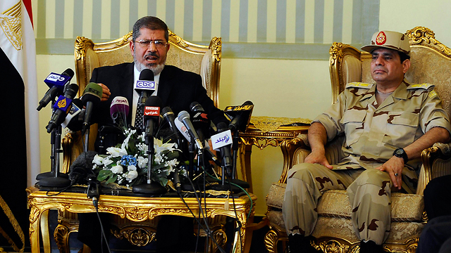 Morsi as president with Sisi at his side - May 2013 (Photo: Reuters)