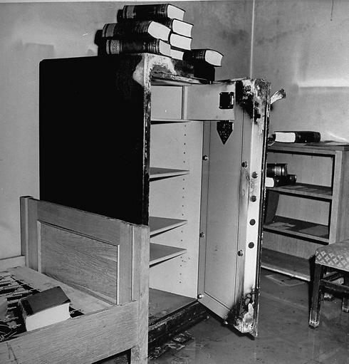 A pile of books over a safe that was broken open (Photo: GettyImages)