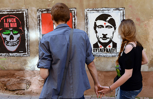 "לשים סוף לפוטלר". פוטין בדמותו היטלר בכתובת גרפיטי בעיר לבוב האוקראינית (צילום: AFP) (צילום: AFP)
