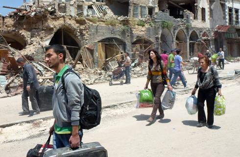 People returning to their homes in Homs (Photo: AFP)