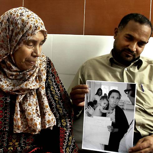 Palestinian refugees Fathiyeh Sattari, 62, and her son Hassan, 40, look at their photograph that was taken at the Rafah UN aid agency clinic in 1975 (Photo: AP) (Photo: AP)
