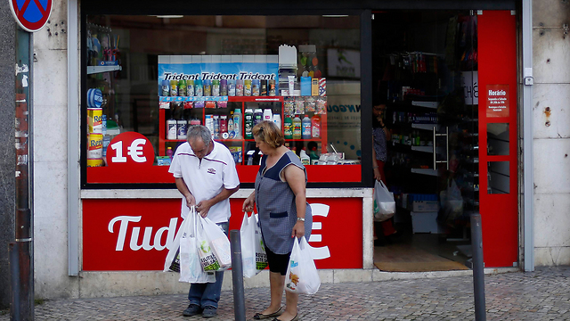 ביציאה מחנות בפורטוגל שבה כל המוצרים נמכרים באירו אחד (צילום: רויטרס) (צילום: רויטרס)