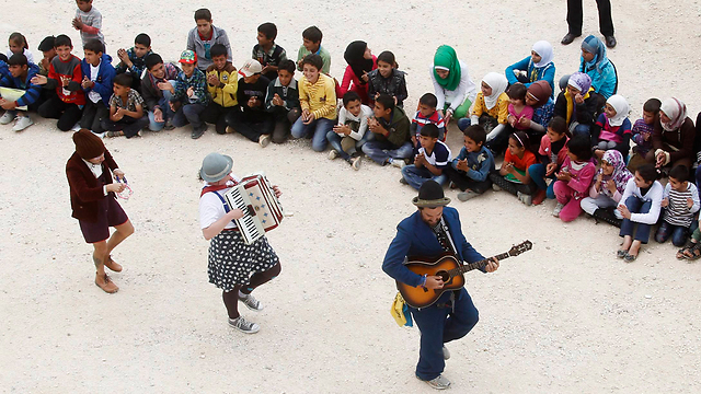 Clowns perform for Syrian refugee children in a camp in Lebanon (Photo: Reuters)