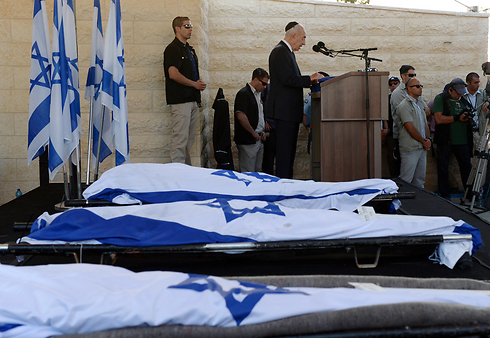 Then-president Shimon Peres speaks at the joint funerals of the three boys. (Photo: GPO)