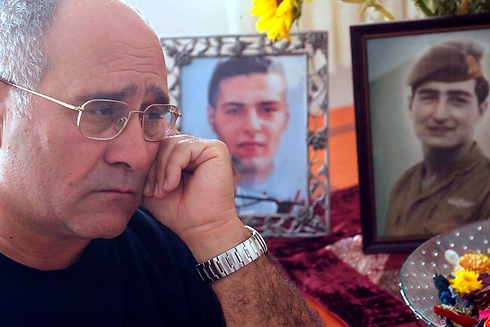 Haim Avraham with photos of his son and brother, both fallen soldiers (Photo: Shaul Golan)  (Photo: Shaul Golan)