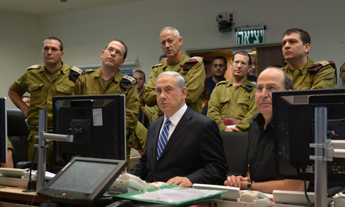 Then-IDF chief Gantz (standing in the middle), Prime Minister Netanyahu and then-Defense Minister Ya'alon (both seated) at the Kirya IDF headquarters during Operation Protective Edge (Photo: GPO)