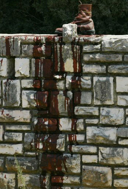 Blood-stained army boots on stone wall in Kfar Giladi, 2006 (Photo: Reuters) (Photo: Reuters)