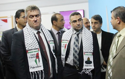 British Consul General Alastair McPhail, left, wearing the scarf (Photo: Islamic Relief Palestine)  (Photo: Islamic Relief Palestine)