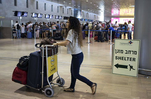 A sign pointing the way to bomb shelters at Ben Gurion Airport during Operation Protective Edge (Photo: AFP)