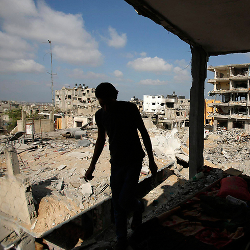 Palestinian man returns to destroyed home in Gaza (Photo: Reuters) (Photo: Reuters)