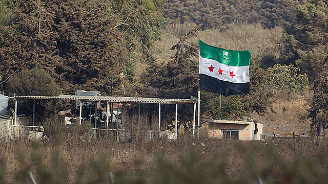 הדגל של המהפכה הסורית במעבר קוניטרה אתמול                 (צילום: AFP) (צילום: AFP)