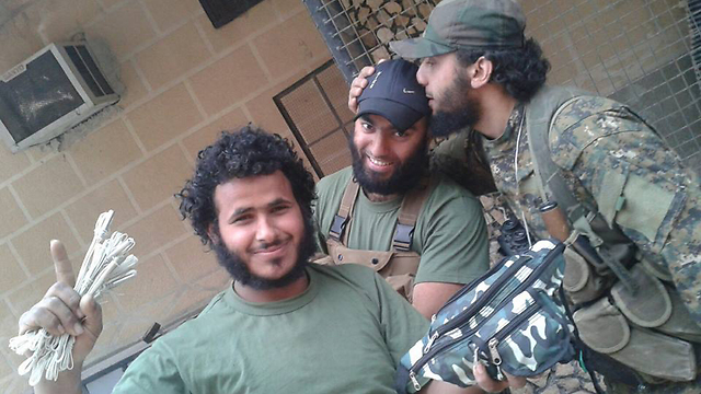Rabiya Shahade (center) with alleged Islamic State fighters.